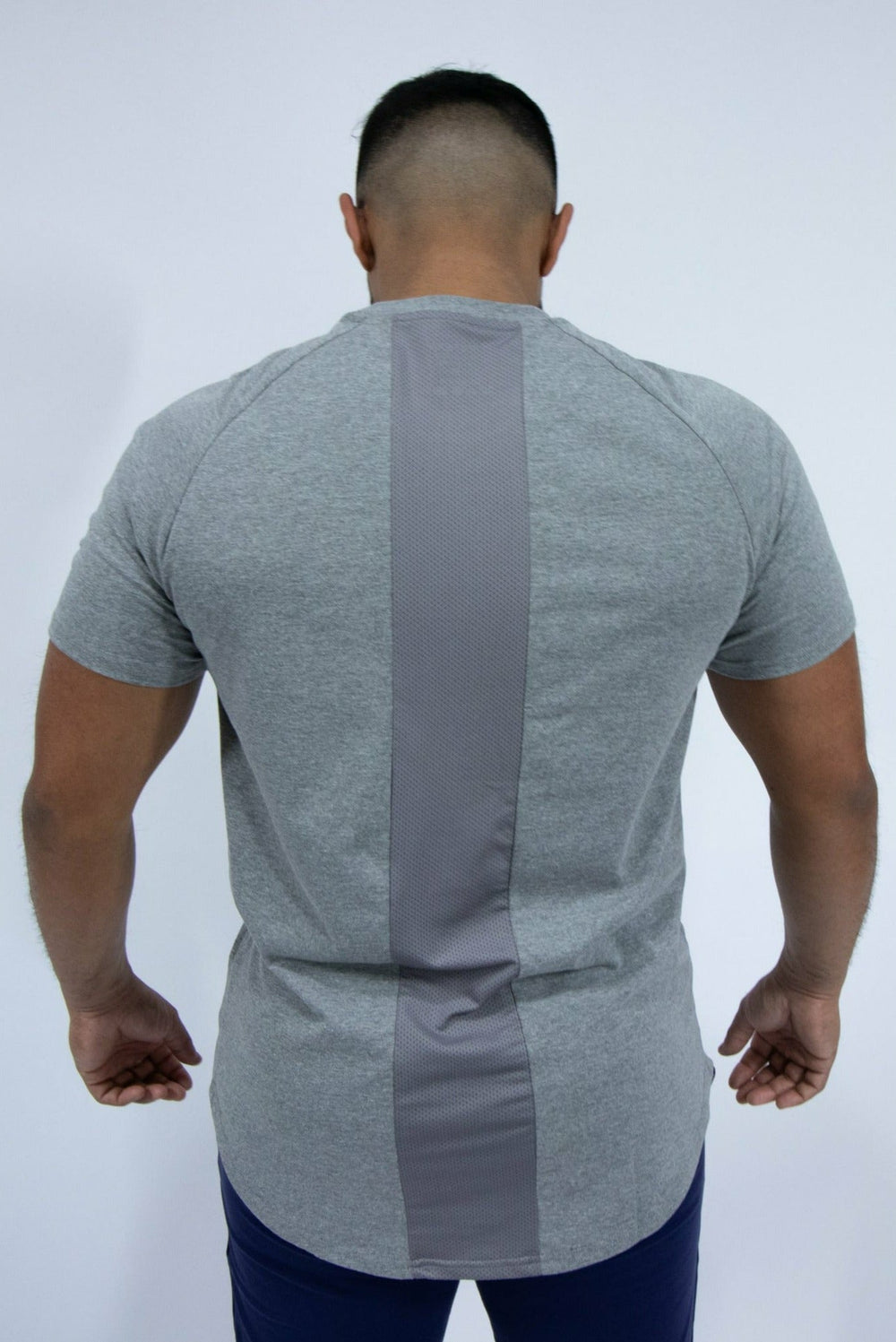 Our IXK Cotton Tee is perfect for intense workouts, errands and rest days. With it's high-quality and sleek finish you'll never want to take it off. Available in Blue/Black/Grey. Back View in Grey.