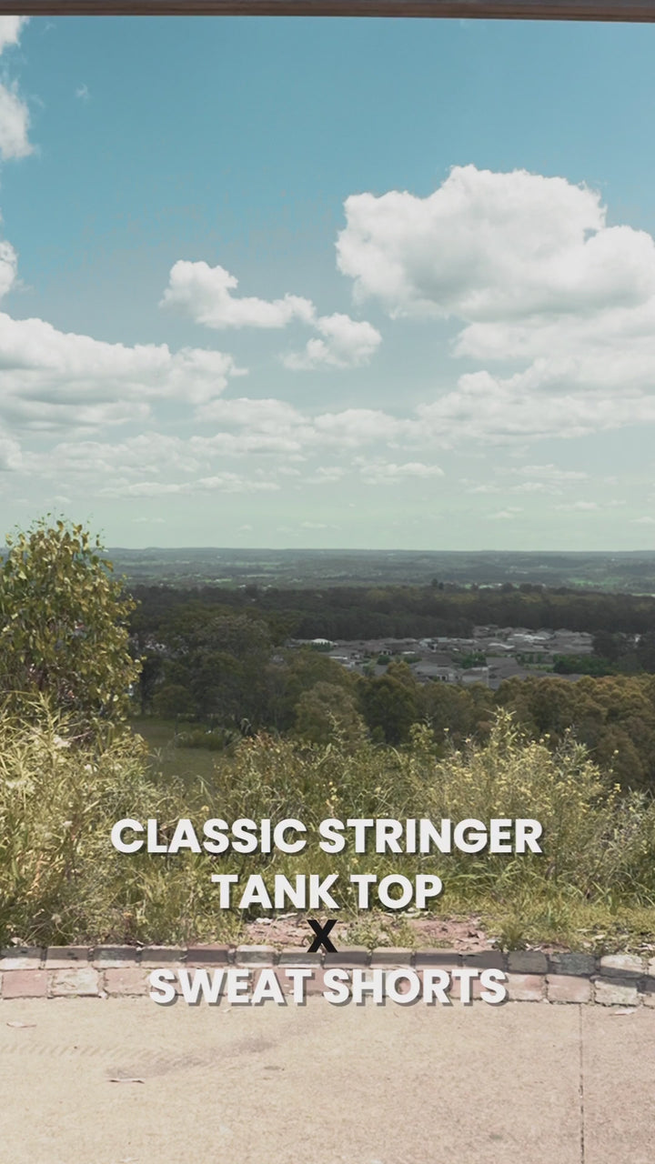 Video of Classic Stringer and Black Cotton Sweat Shorts. Natural background and captions.